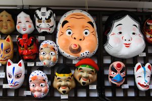 Tokyo, Japan - October 10, 2012: group of traditional japanese masks in a stand for bought in Tokyo